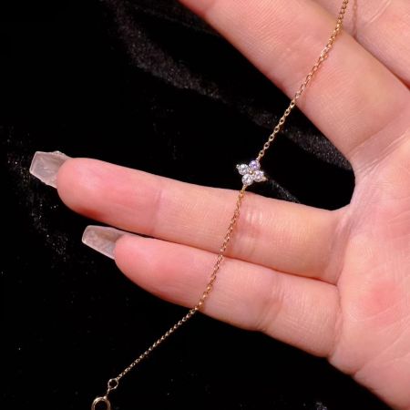 Close-up view of the dainty gold-plated 925 silver anklet with a sparkling CZ four-leaf clover charm.