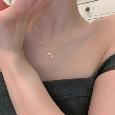 Showcase of the gold necklace with its celestial-themed pendant.