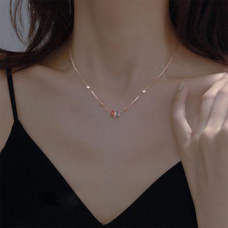 Detailed view of the gold rainbow pendant necklace.