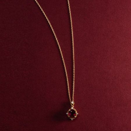 Detailed view of the vintage ruby pendant on its 18K gold-plated chain.