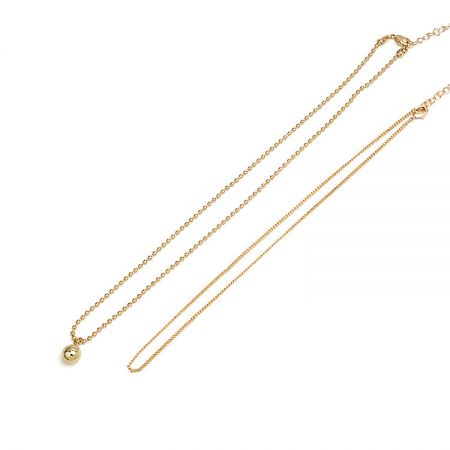Double Chain Layered Mini Ball Necklace - Close-up of the Double Chain Layered Mini Ball Necklace, showing the spherical pendant and delicate chain details.