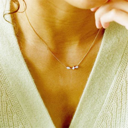 Model wearing the gold geometric cluster zircon necklace, demonstrating its elegant drape and style.