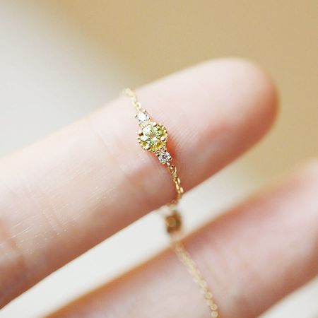 Detailed view of another ring from the set, featuring a unique yellow gemstone design.