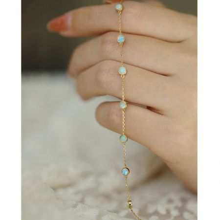 Another view of the mini opal chain bracelet, highlighting its shimmering stones.
