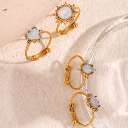 An assortment of high-end adjustable opal rings in various shapes.