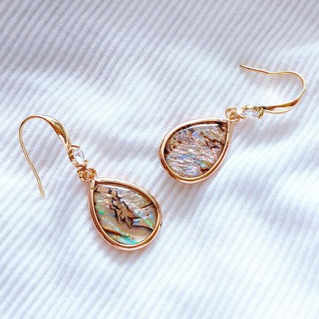 Side view of the shell teardrop fish hook earring, displaying its elegant design and gold finish.