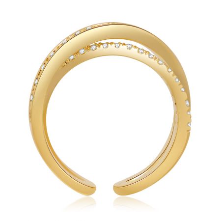 Angled view of the open-ended gold ring, showing the shimmer of the embedded white gemstones.