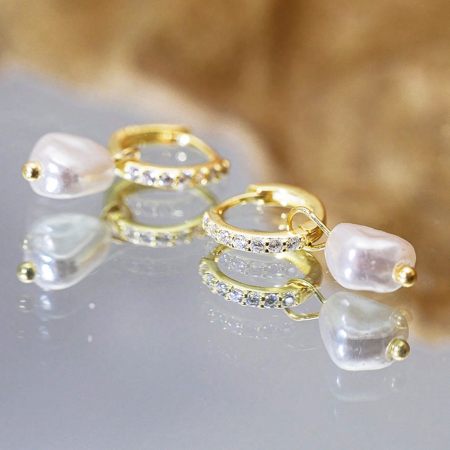 A detailed view of the gold-plated baroque pearl earrings, showing the craftsmanship and sparkle of the zirconia.