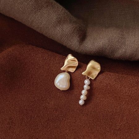 Another unique design from the set of five asymmetrical gold and pearl earrings.