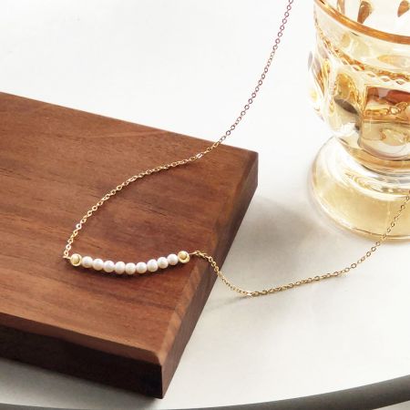 The freshwater pearl necklace set arranged on a wooden display, highlighting its aesthetic appeal.