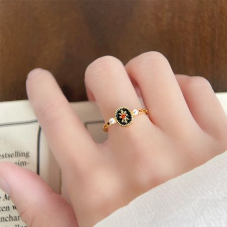 Retro 14k Gold Plated Black Enamel with Pearl and Zircon Open Finger Rings - A detailed view of a retro 14k gold plated ring from the five-piece set, featuring a black enamel flower design and delicate pearl accents.