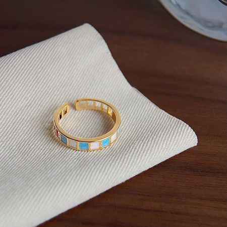 A gold-plated ring with striking blue and white stone details, part of the five-piece set.
