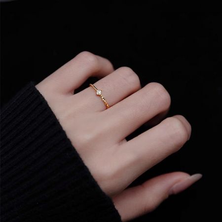 Close-up of the gold-plated 925 silver adjustable ring worn on a finger, highlighting its minimalist design.