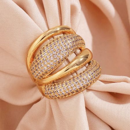 Side profile of a chunky gold plated dome ring, highlighting the sparkling cubic zirconia pave.
