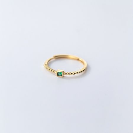 Detailed side view of the gold-plated sterling silver emerald ring.