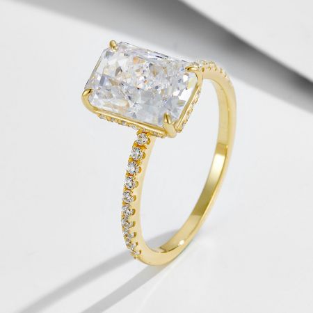 Bague de fiançailles en CZ taille radiant inspirée par Taylor Swift en gros et ensemble de bande éternité en argent 925. - Gros plan de la bague de fiançailles en CZ taille radiant inspirée par Taylor Swift en finition argent sterling 925 plaqué or, montrant la pierre principale et la bande pavé.