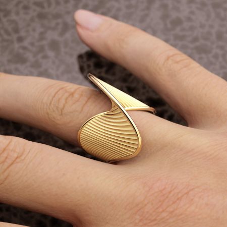 Gros plan d'une bague en finition or texturée, faisant partie de l'ensemble de 5 pièces en acier inoxydable.