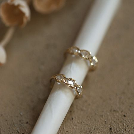 Front and side view of the 14K gold plated teardrop huggie earrings.