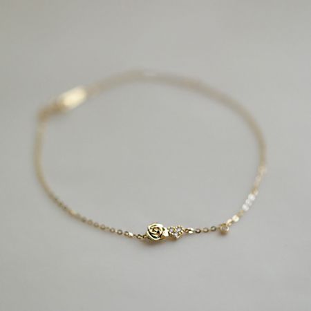Another perspective of the tiny rose flower charm bracelet, highlighting its delicate design.