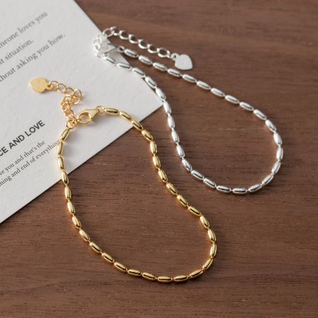 Conjunto de 5 pulseras de cuentas de arroz Simple Beauty de plata esterlina 925 - Un conjunto de pulseras de cuentas de arroz Simple Beauty en acabados de plata esterlina 925 y dorado, exhibidas elegantemente.