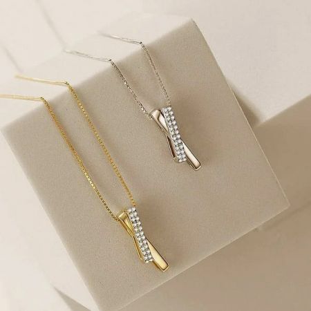 Top-down view of the interlocking pave CZ necklaces in gold and silver.