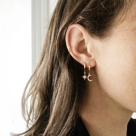 A clear shot of the gold-plated star and moon earrings against a white background.