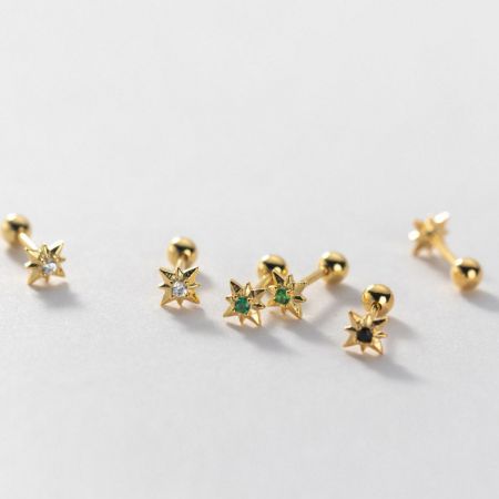 Assortment of gold star earrings showcasing different colored gemstones.
