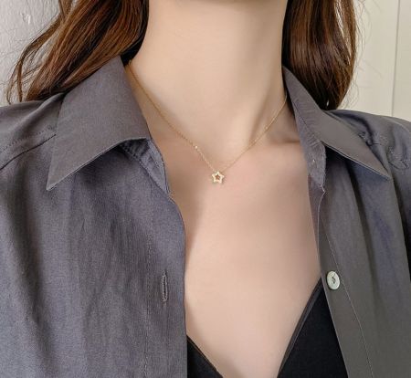 Modell som visar 925 Sterling Silver Stjärnhalsbandet för att framhäva dess längd och hur det kompletterar en outfit.