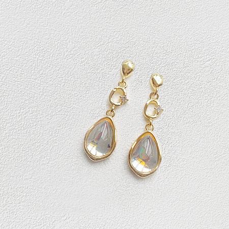 Front view of the gold teardrop earrings showcasing the clear gemstones.