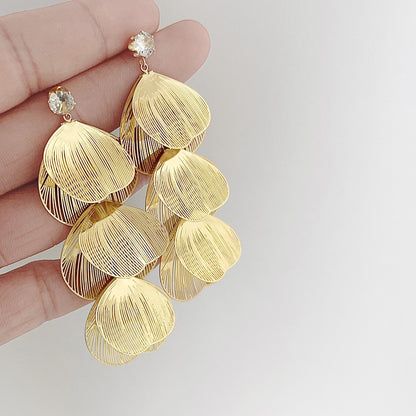 Elegant gold teardrop earrings adorned with sparkling clear gemstones.