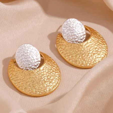 Product shot of the gold and silver textured crescent moon earrings.