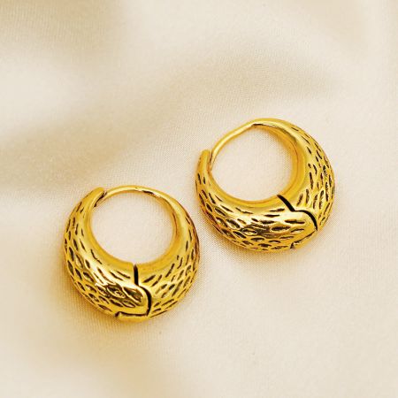 A single gold-plated hoop earring showcasing its detailed texture and hinged closure.