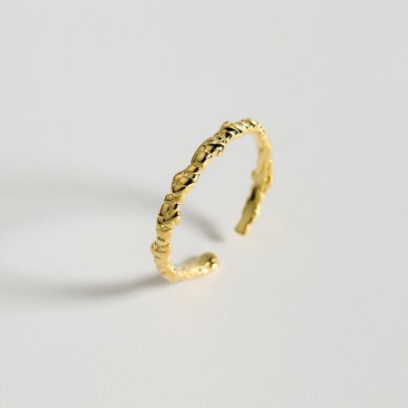 Close-up of the gold-plated version of the adjustable braided ring.