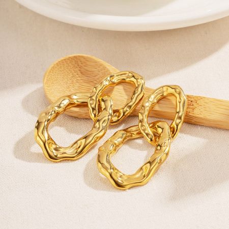 A pair of gold earrings with a unique wavy chain link design.