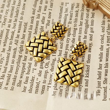 Component pieces of the woven metal earrings, showcasing the craftsmanship.