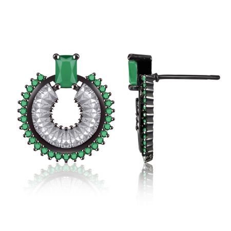 Angled view of the circular emerald and clear gemstone earrings, highlighting the intricate prong setting on a black base.