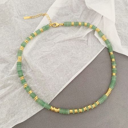 Detailed view of the green natural bead necklace with elegant gold accents.