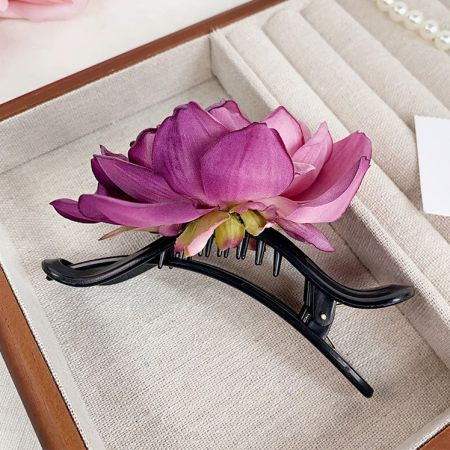 A beautiful pink lotus flower claw hairclip, perfect for a summer look.