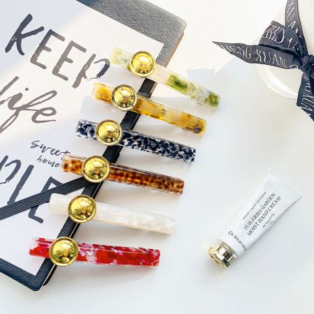 An elegant arrangement of leopard print hair clips alongside beauty products.
