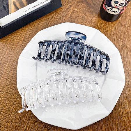 The black and transparent hair clips shown side-by-side for comparison.