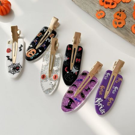 Two sets of Halloween 'Bride' themed hair clips in purple and white glitter.