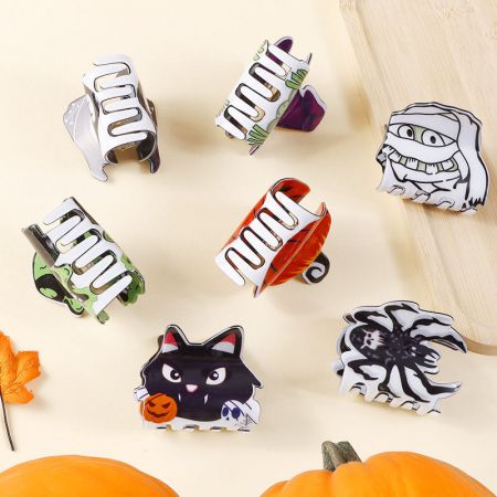 Festive arrangement of Halloween-themed claw hair clips on display.