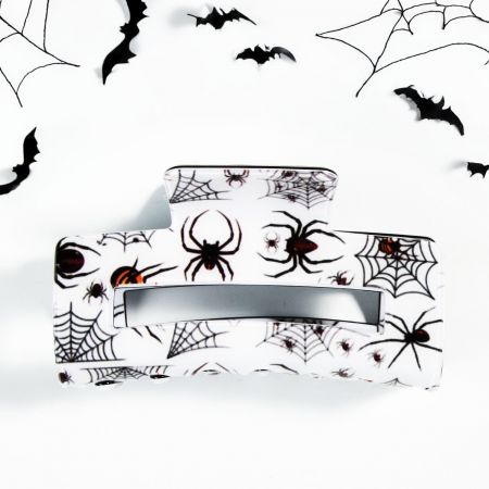 Halloween Claw Clip: Cartoon Pumpkin and Ghost Accessories for Women and Girls - A collection of festive Halloween-themed claw hair clips, featuring designs like pumpkins, ghosts, and spider webs, displayed on a neutral background.