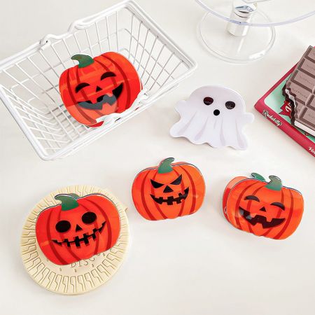 A collection of Halloween-themed accessories including the ghost and pumpkin hair clips.