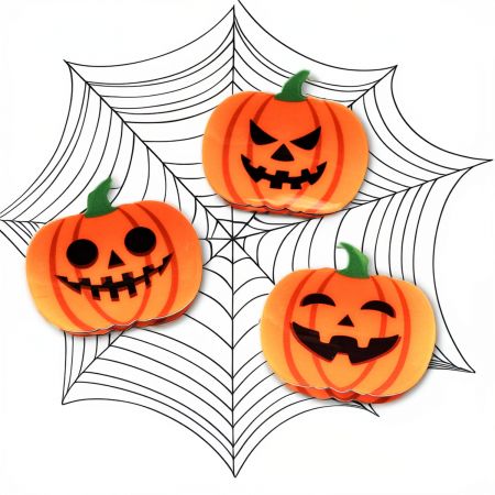 Another angle of the pumpkin hair clip, highlighting its glossy finish and vibrant color.