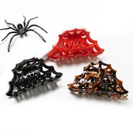 Three cobweb claw clips in black, red, and brown.