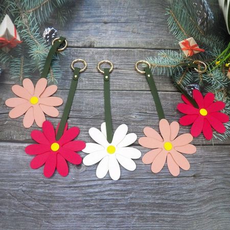 Assortment of colorful handmade flower keychains ready for customization.