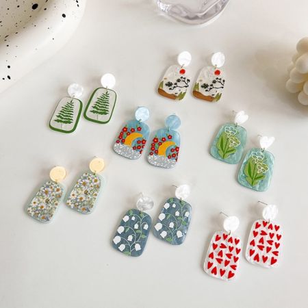 Pendientes Grandes de Acrílico y Resina Geométricos - Una colección de pendientes de resina y acrílico con patrones geométricos y abstractos coloridos de JR Fashion Accessories, exhibidos sobre un fondo blanco.