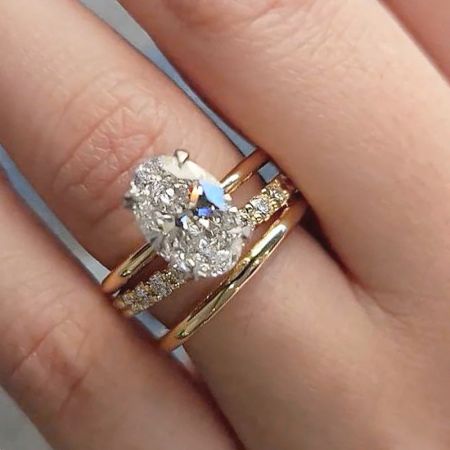A set of three gold rings with a prominent heart-shaped diamond solitaire, available for custom orders.