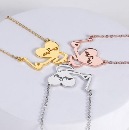 Collana a Forma di Cuore Arabo Personalizzata - Tre collane personalizzate a forma di cuore arabo esposte affiancate in finiture oro, oro rosa e argento, che mostrano le opzioni di placcatura disponibili.